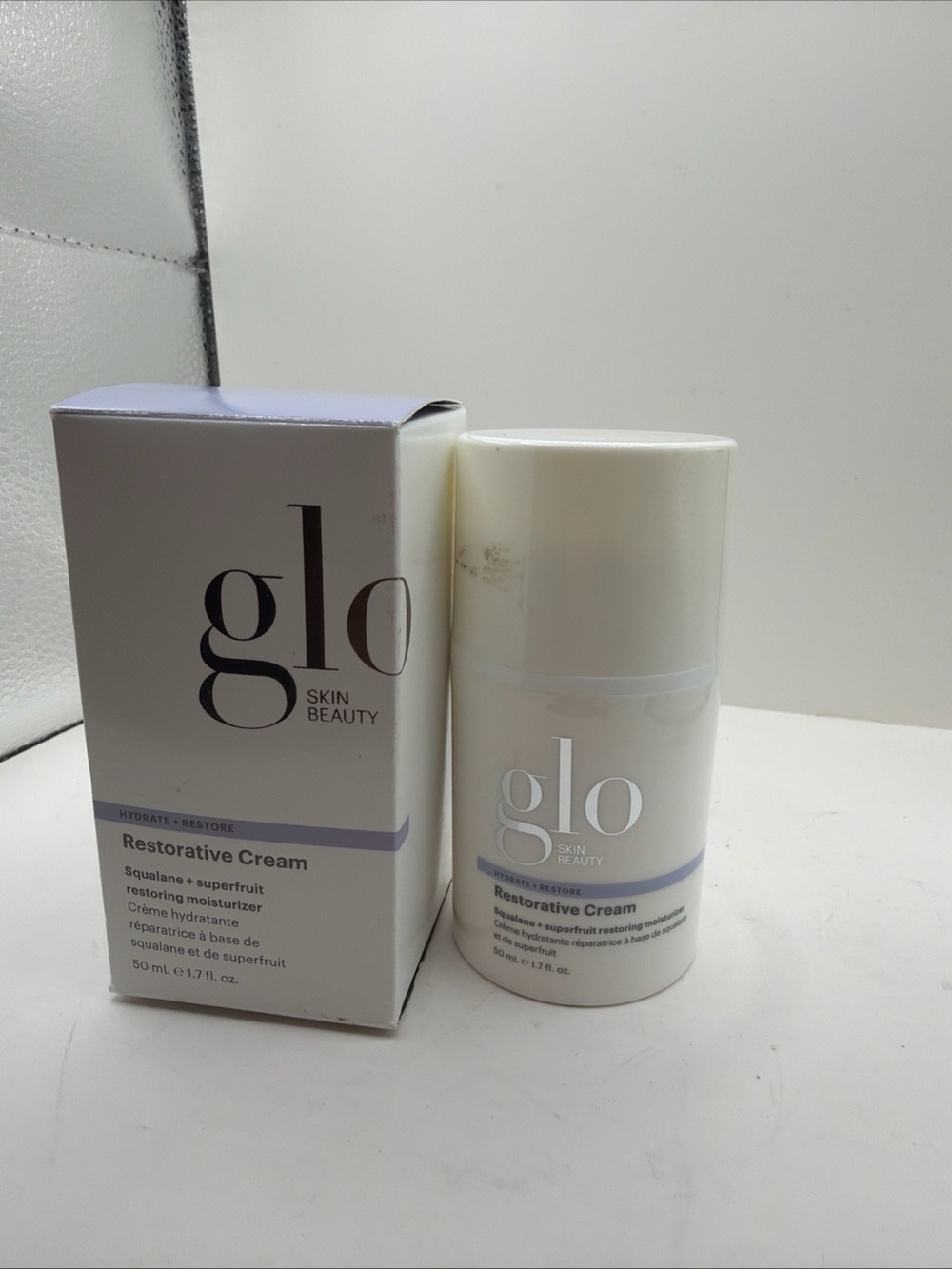 Glo Skin Beauty Restorative Cream in White with Light Purple Accents